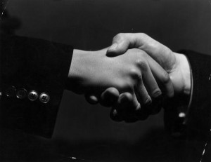 16th February 1938: A close-up of two hands grasping each other in a firm handshake. (Photo by Fox Photos/Getty Images)